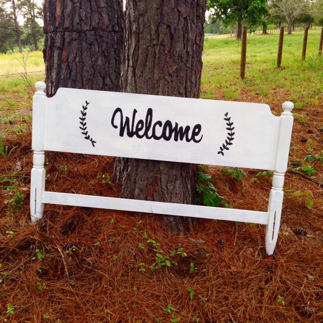 Headboard repurposed as a Welcome sign