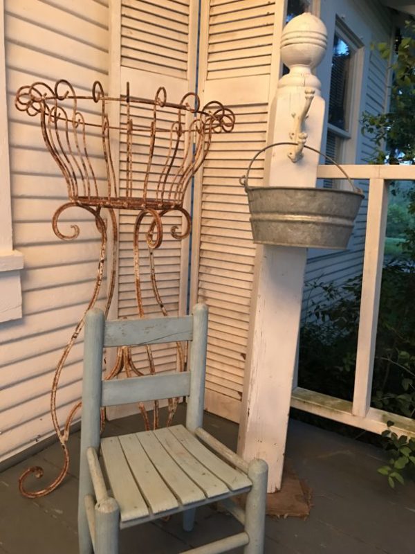 Old column on porch with bucket