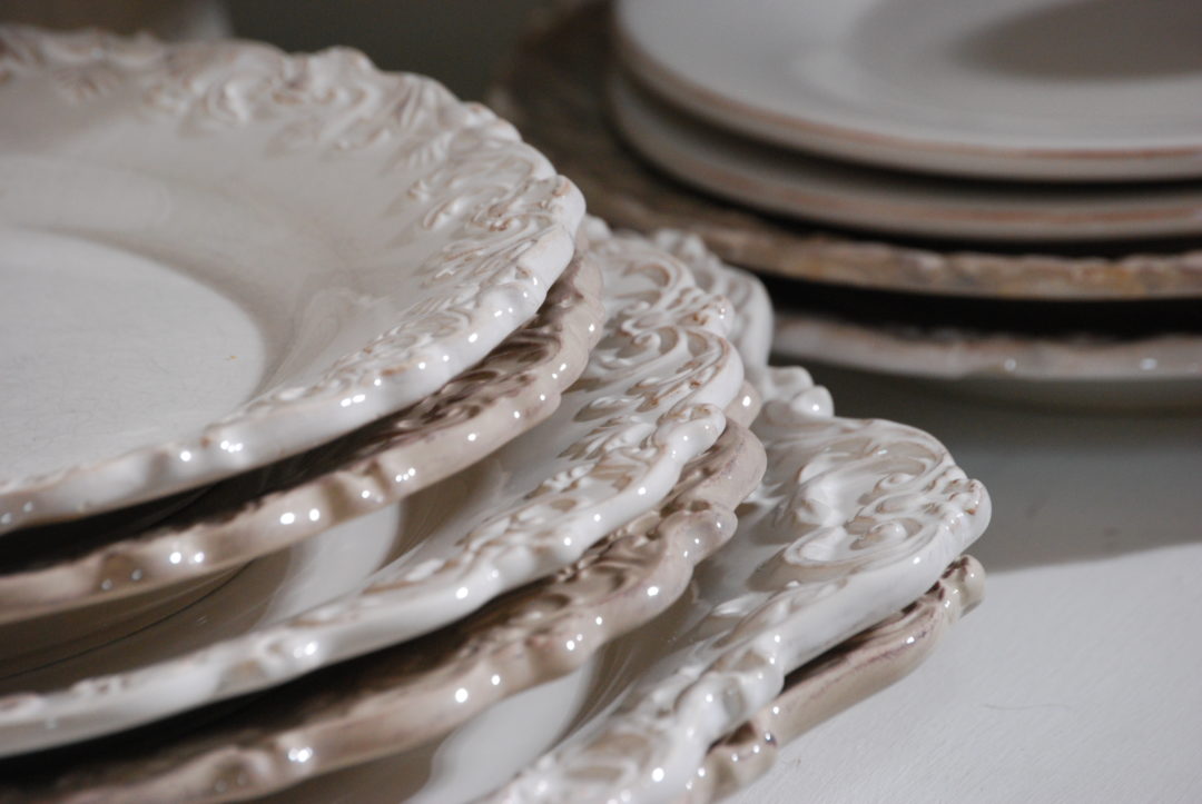 Stacked white dishes with scrolled detail