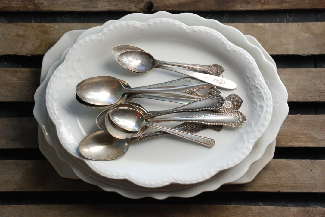 antique spoons on oval plates
