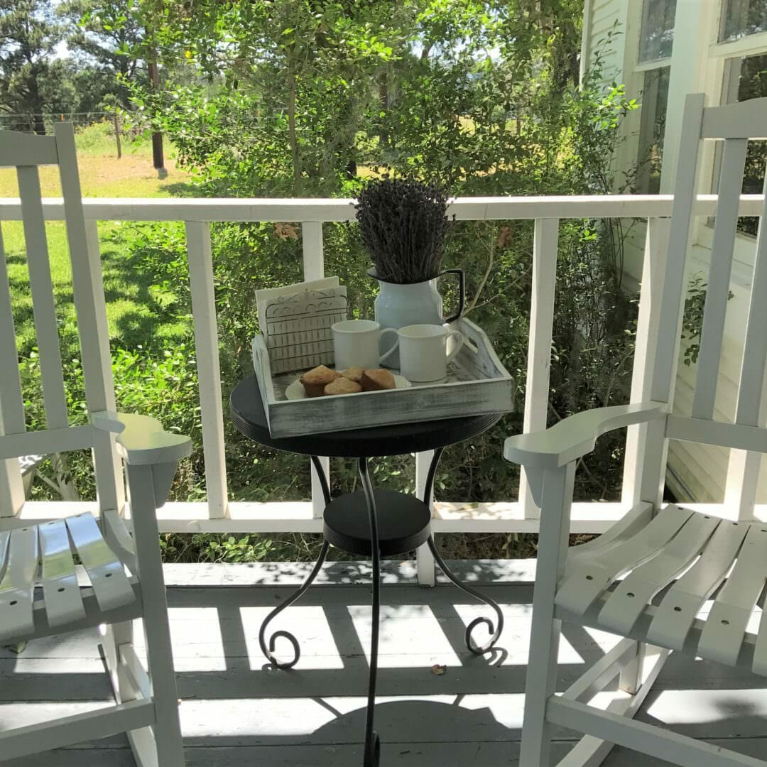 Farmhouse front porch with rocking chairs and breakfast