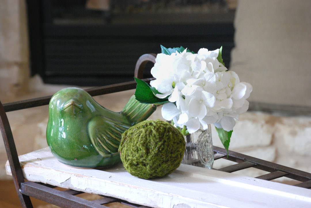 white chippy board on iron bench used in a coffee table refresh