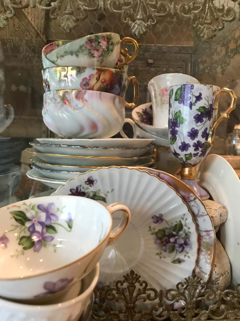 Vintage Teacup collection displayed in glass birdcage