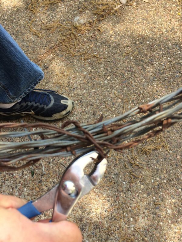 Making a barbed wire wreath using pliers and zip ties