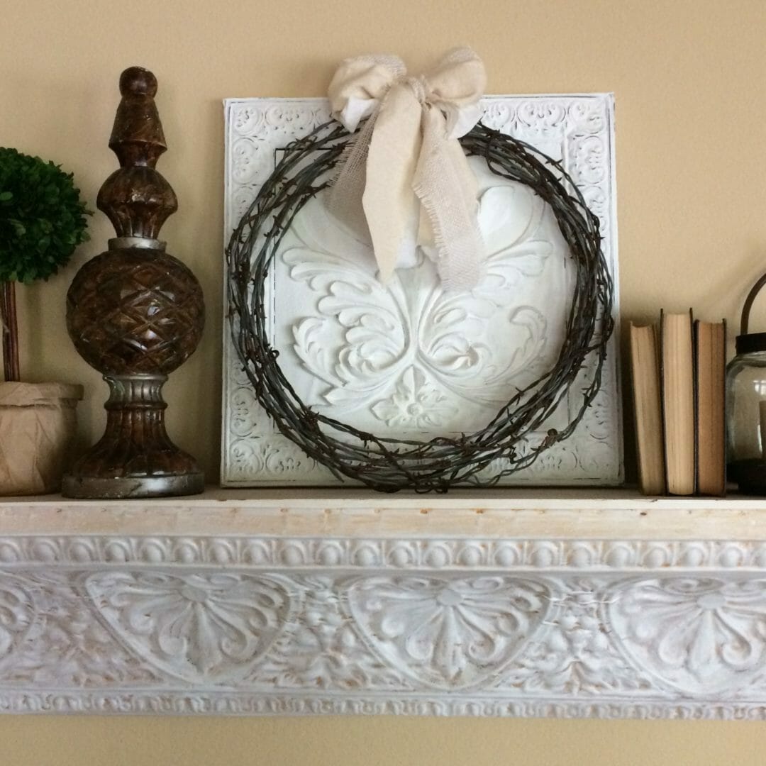 DIY wreath made from barbed wire displayed with bow on a metal shelf