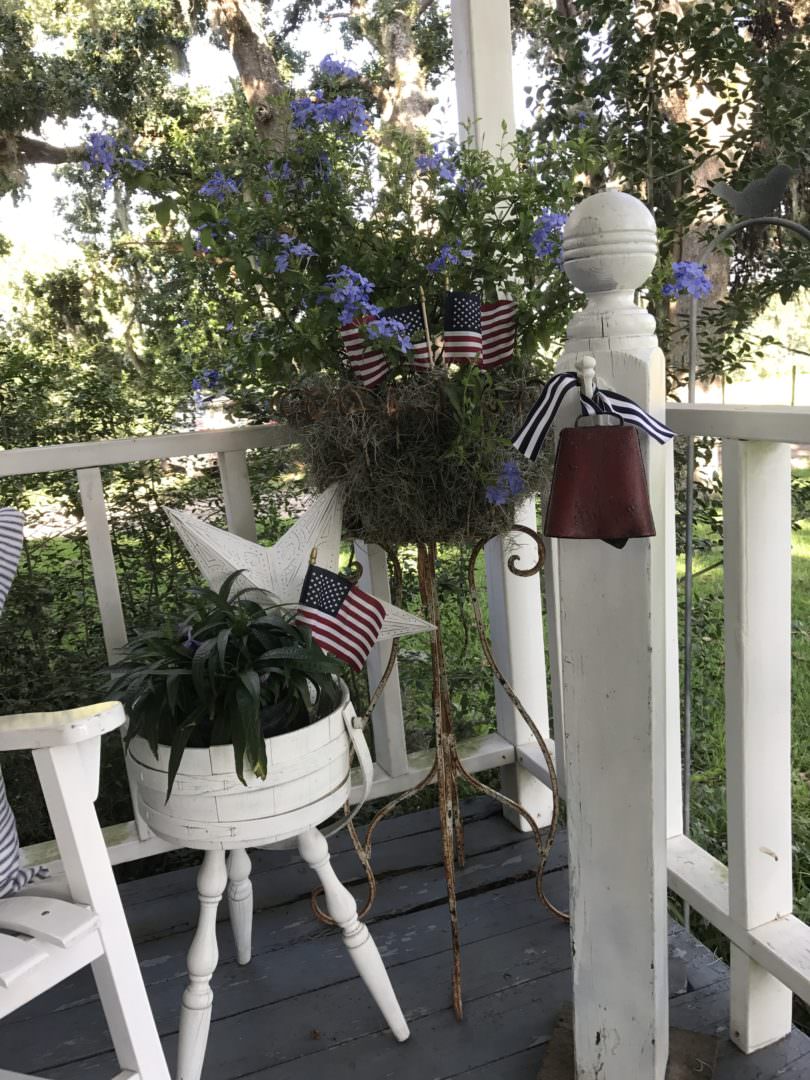 Patriotic decor in plants on farmhouse front porch