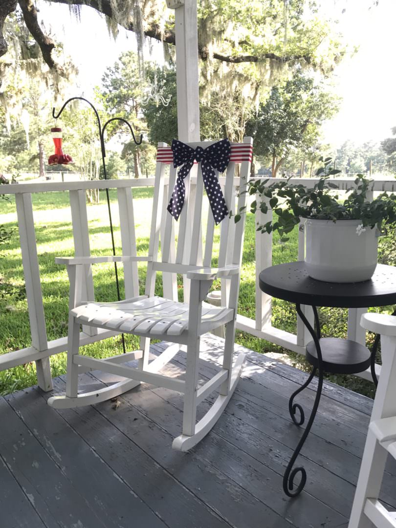 patriotic ribbon fits perfectly on the rocking chair of the farmhouse front porch