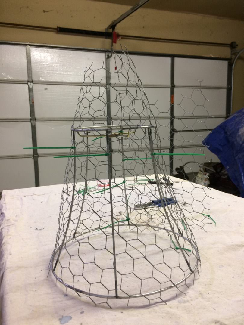 The chicken wire is wrapped around the lamp shade ready for trimming