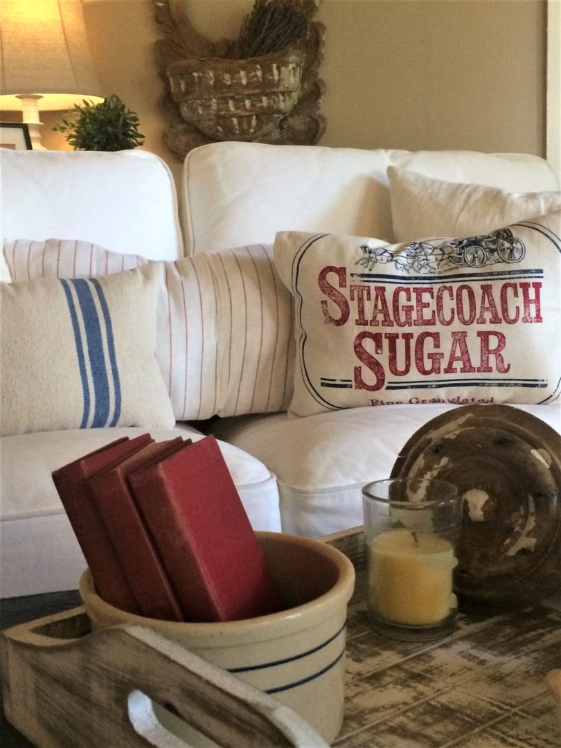 July 4th decor made with vintage fabrics for pillows, vintage books in an old crock