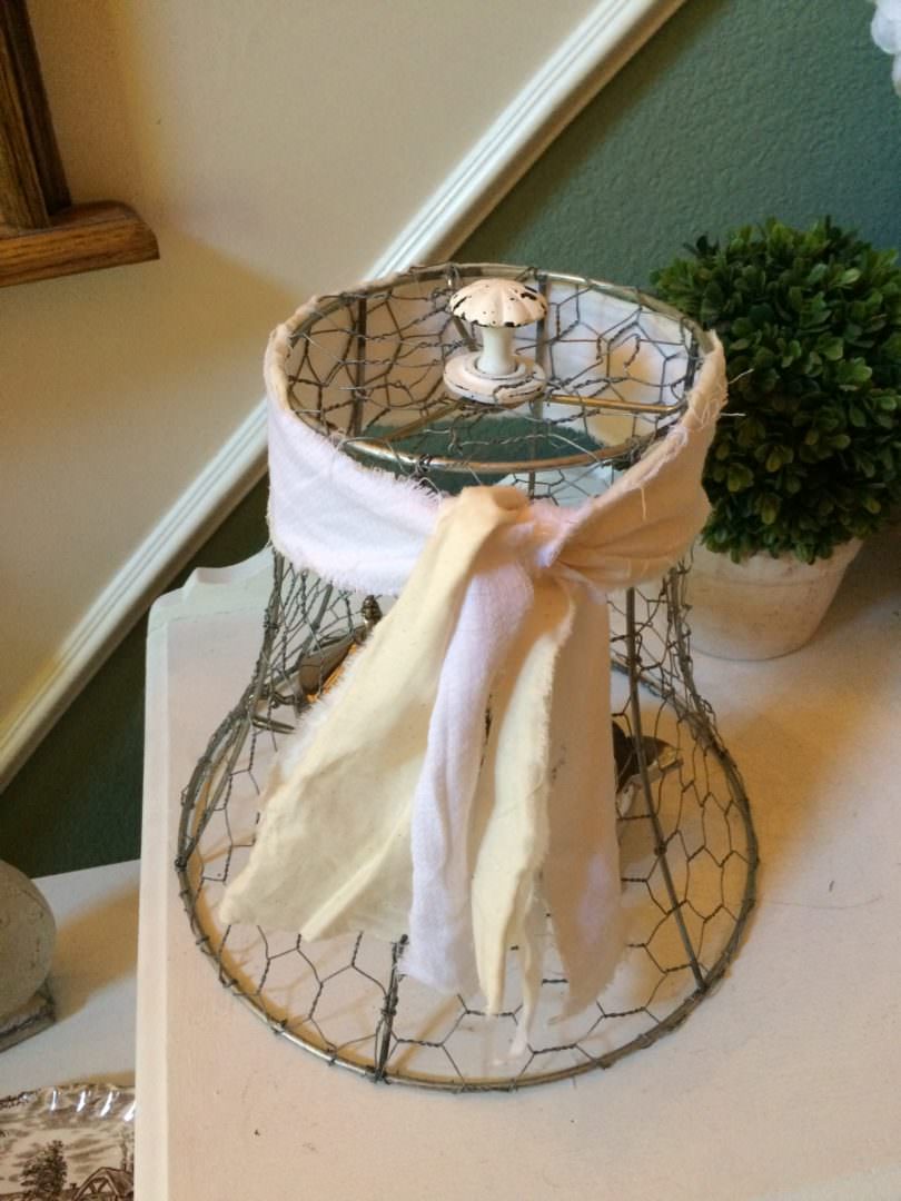 Strips of fabric used to make this chicken wire cloce have a shabby chic look