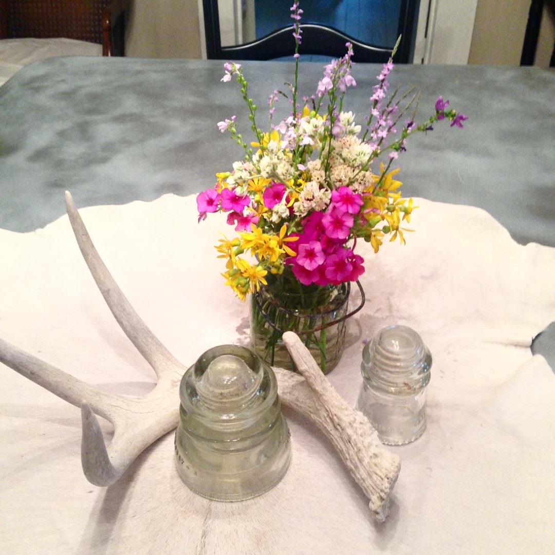 Centerpiece with vintage transformers, antlers, and wild flowers