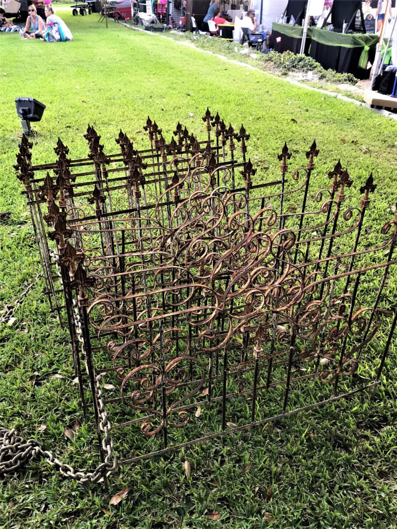 Antique fencing found at an estate sale can be repurposed into a fireplace screen or wall art