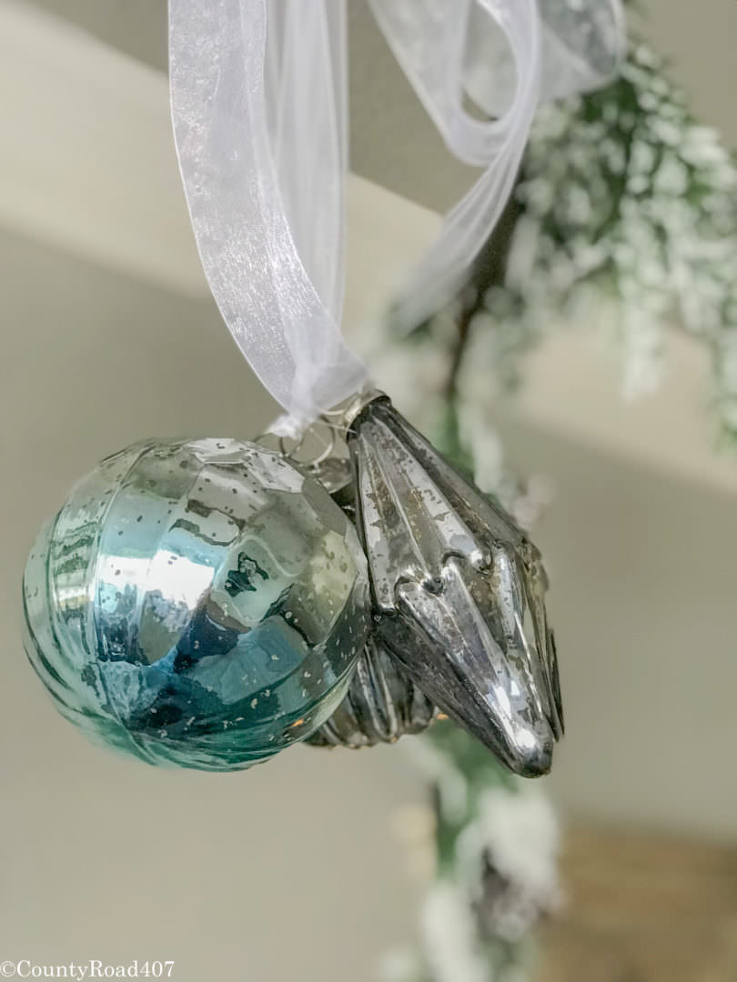 Glass ornaments are hung from the bed. Countyroad407.com