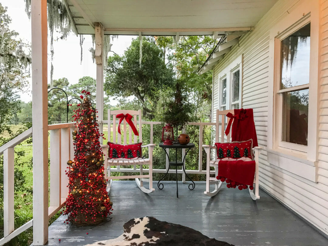 Rock away on this cozy Christmas porch by Countyroad407.com