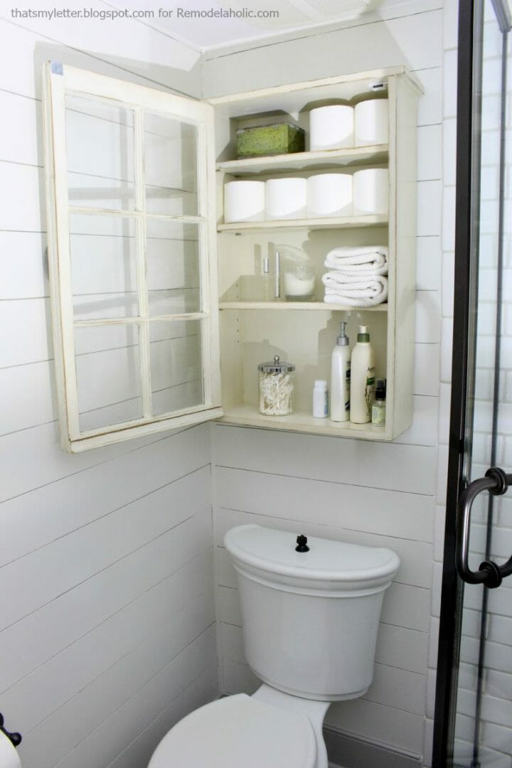 Bathroom storage made by repurposing an old window by Remodelaholic.com 