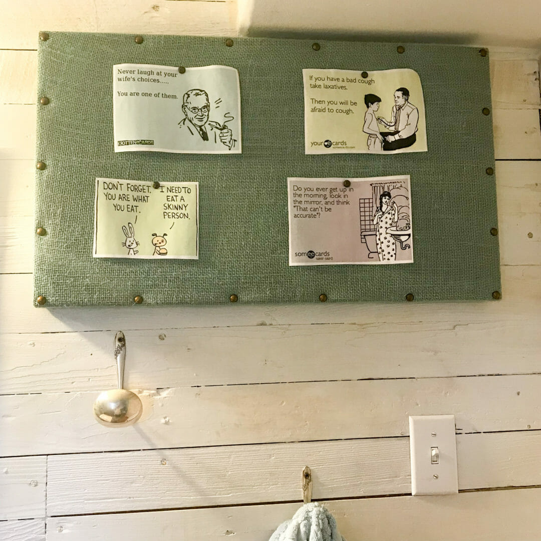 A farmhouse bathroom gets budget ideas with an easy no sew bulletin board. CountyRoad407.com