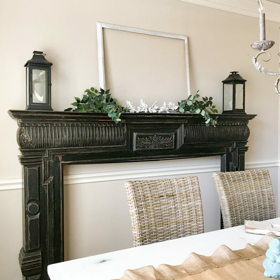 Black distressed mantel in dining room makes a great statement piece. CountyRoad407.com