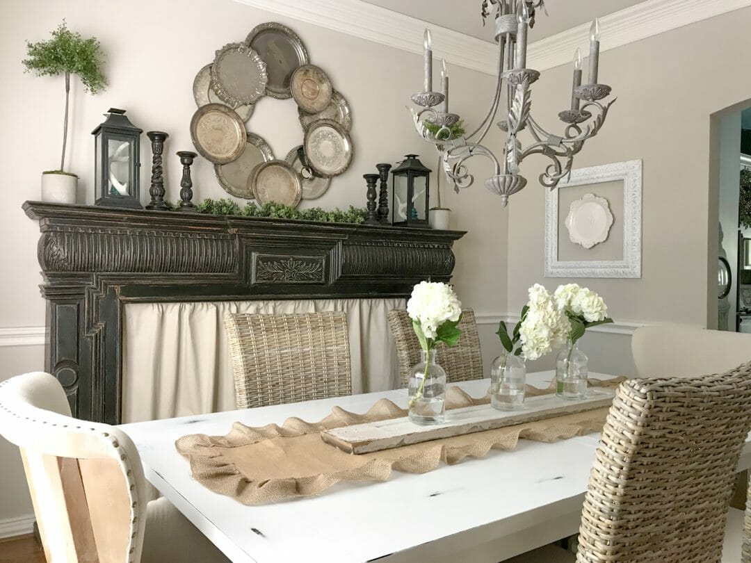 black mantel with candlesticks and silver tray wreath