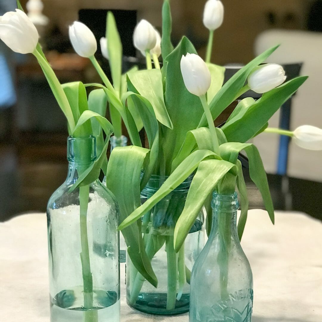 Beautiful vintage bottles are great for centerpieces. CountyRoada407.com