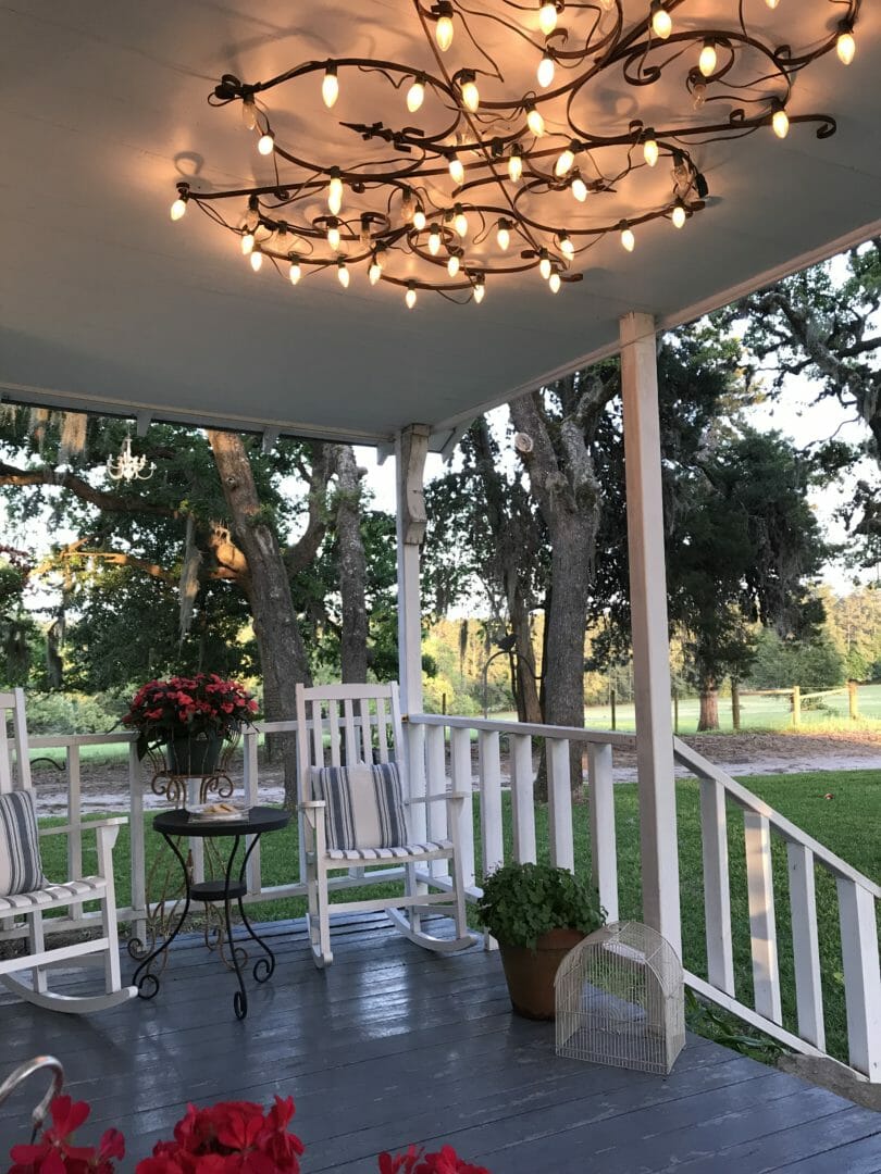Spring farmhouse front porch with homemade light fixture by countyroad407.com