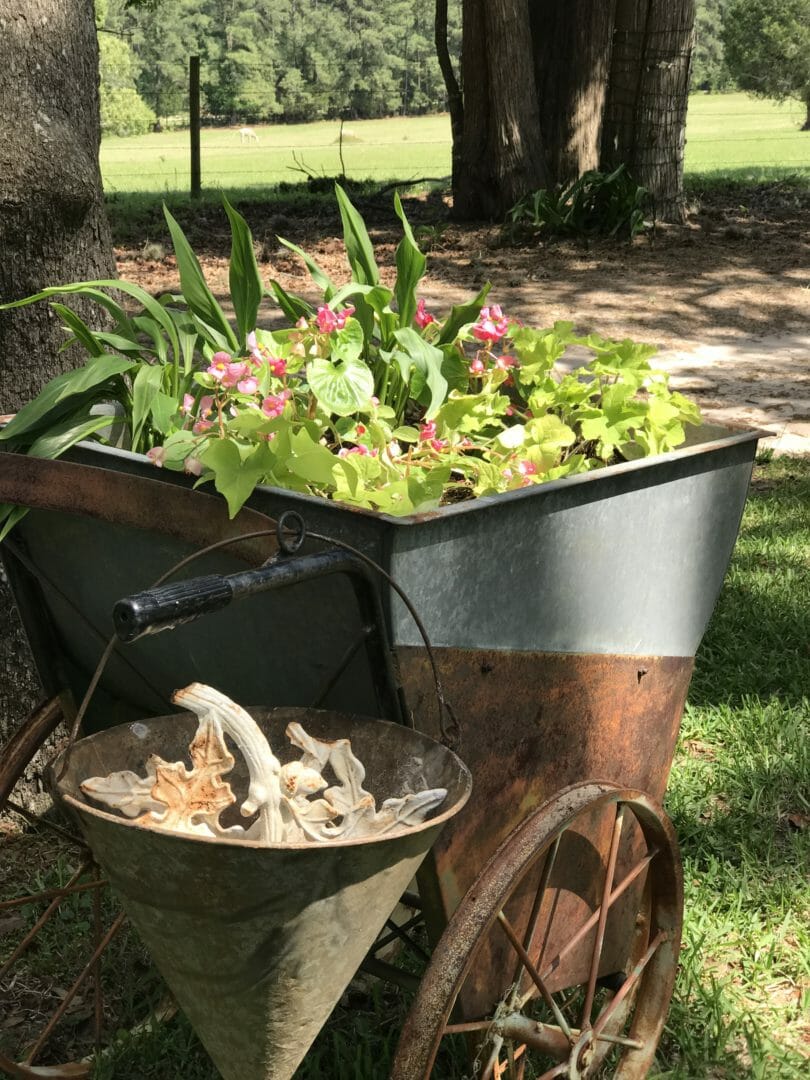 vintage cart holds flowers for a farmhouse spring tour by countyroad407.com