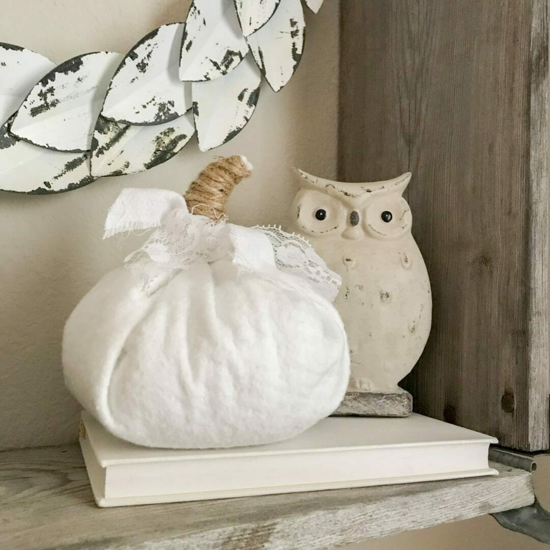white fabric pumpkin with ceramic owl