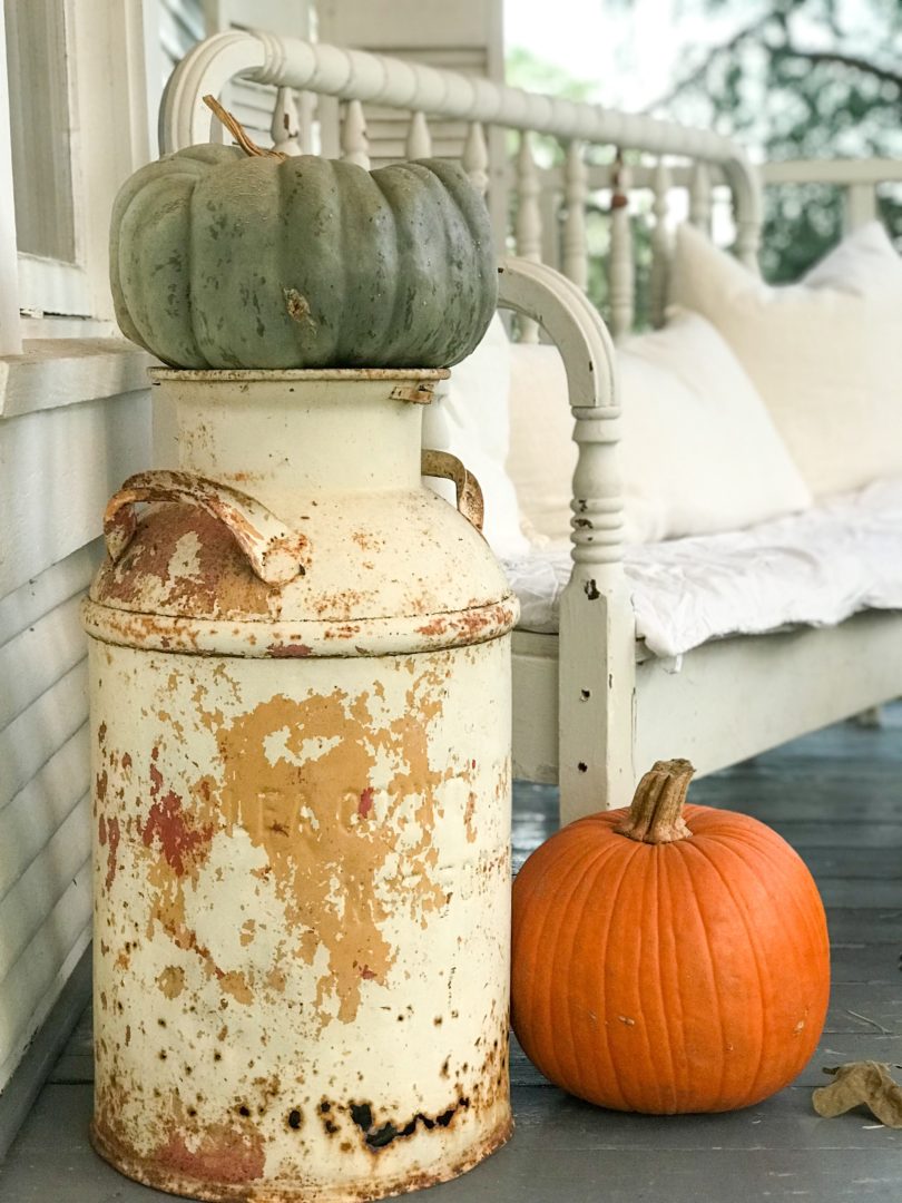 A vintage milk jug works for a farmhouse fall front porch by CountyRoad407.com