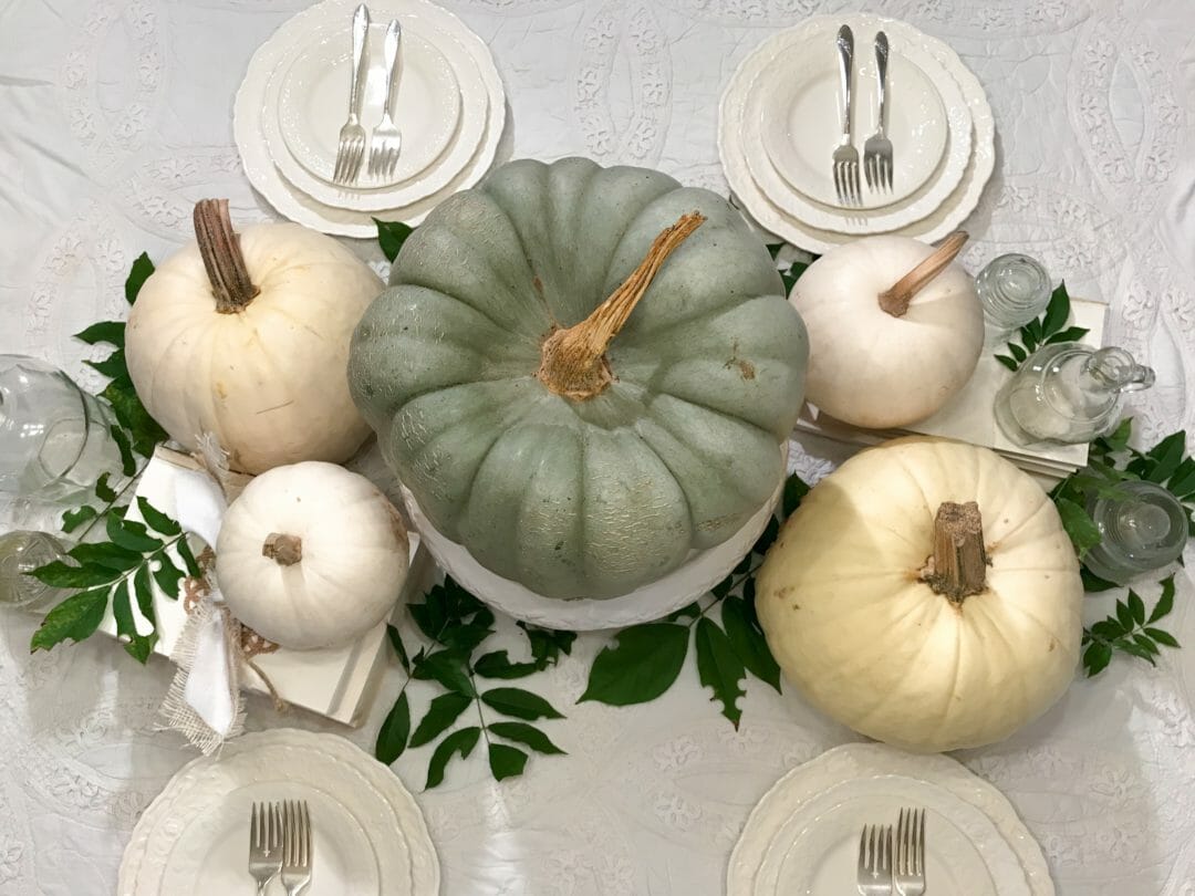 A neutral fall tablescape using vintage items and pumpkins by CountyRoad407.com