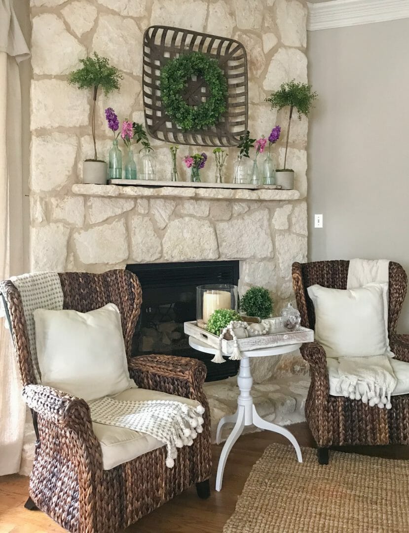 Spring mantel using vintage bottles by CountyRoad407.com #springmantel #springmantle #Springdecor #springdecorating #spring #decor #manteldecor #mantledecor #vintagebottles #bluebottles