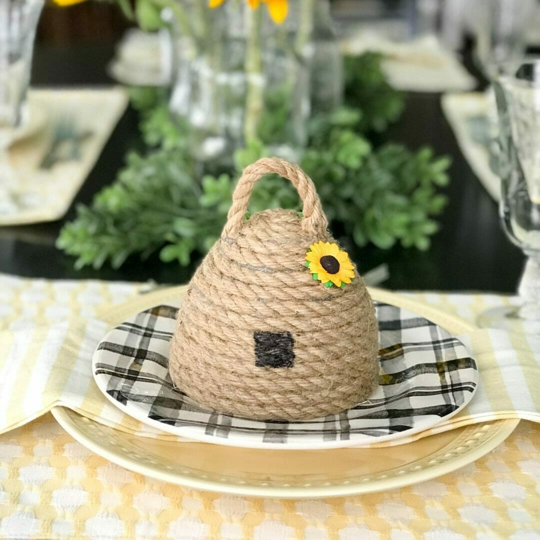bee skep on black and white plate with yellow napkin