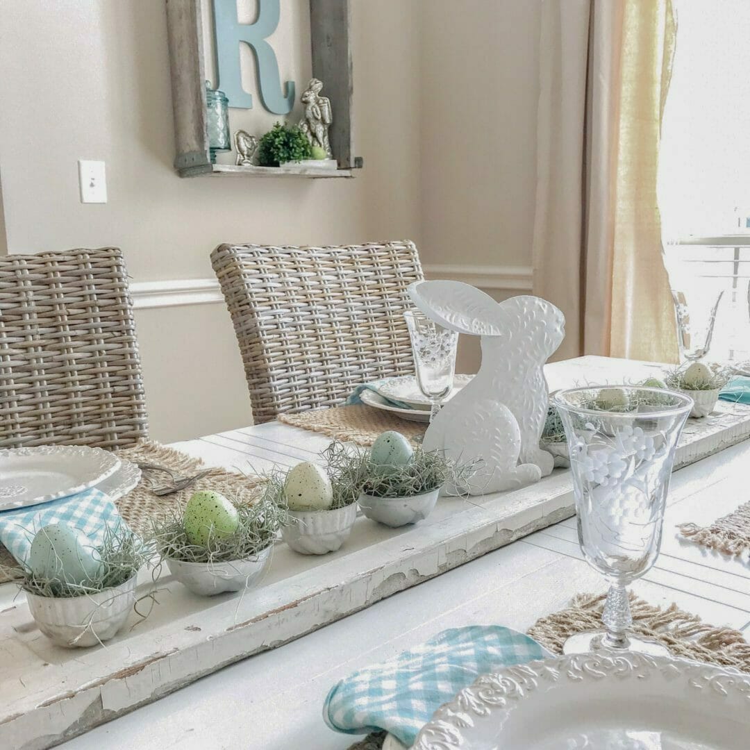 table centerpiece with white tin bunny, vintage Jello molds and eggs