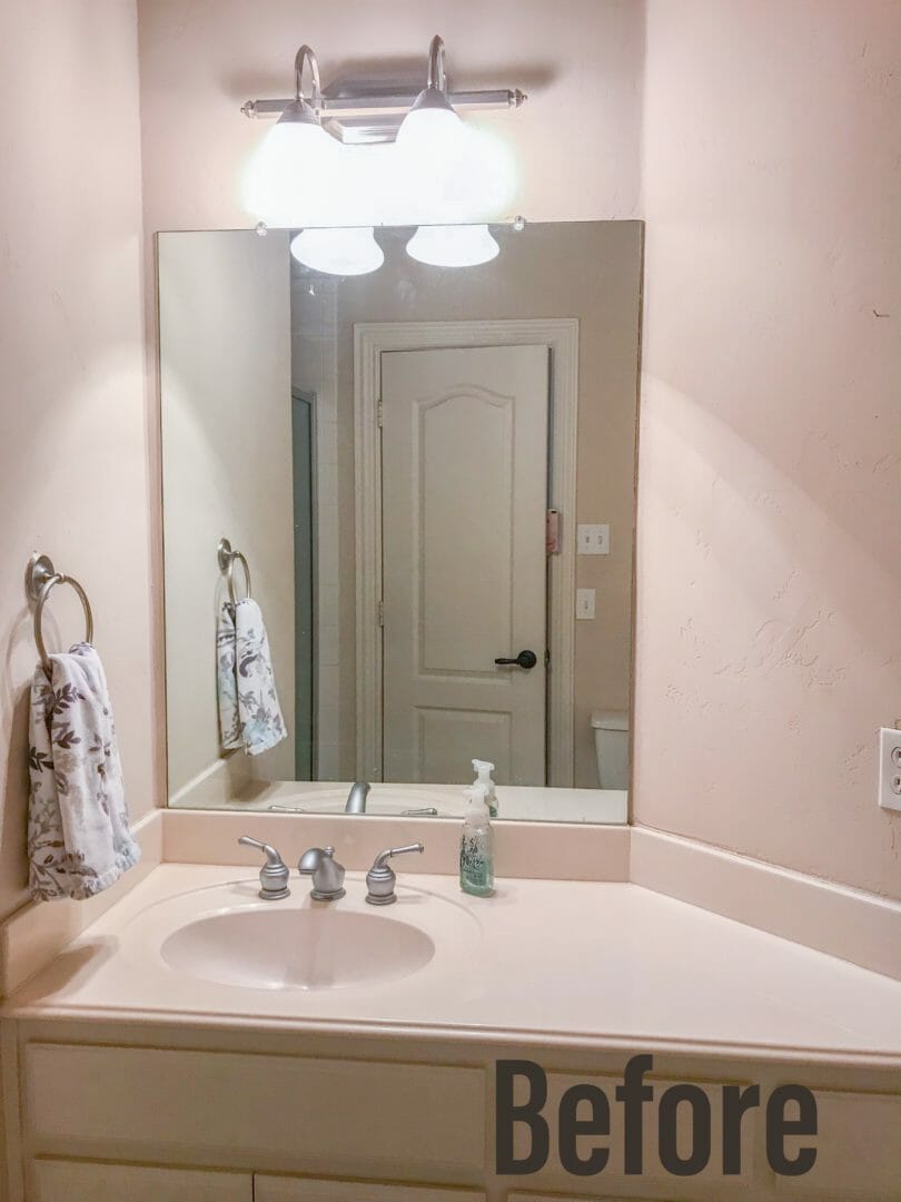 bathroom with mirror, hadn towel, hand soap