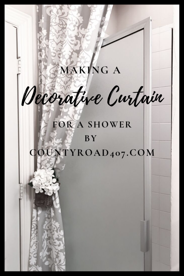 Shower door with curtain and flowers in basket tie back