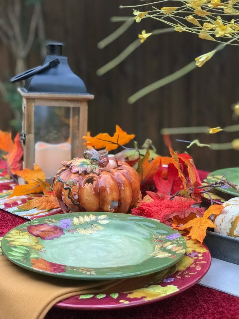 fall plates, lantern and ceramic pumpkins close up