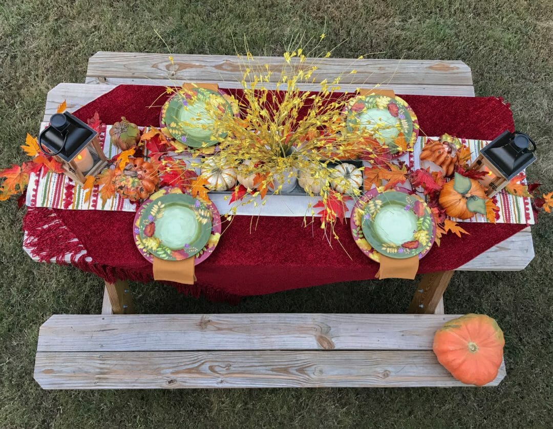 wooden picnic table with full overhead view of fall tablescape