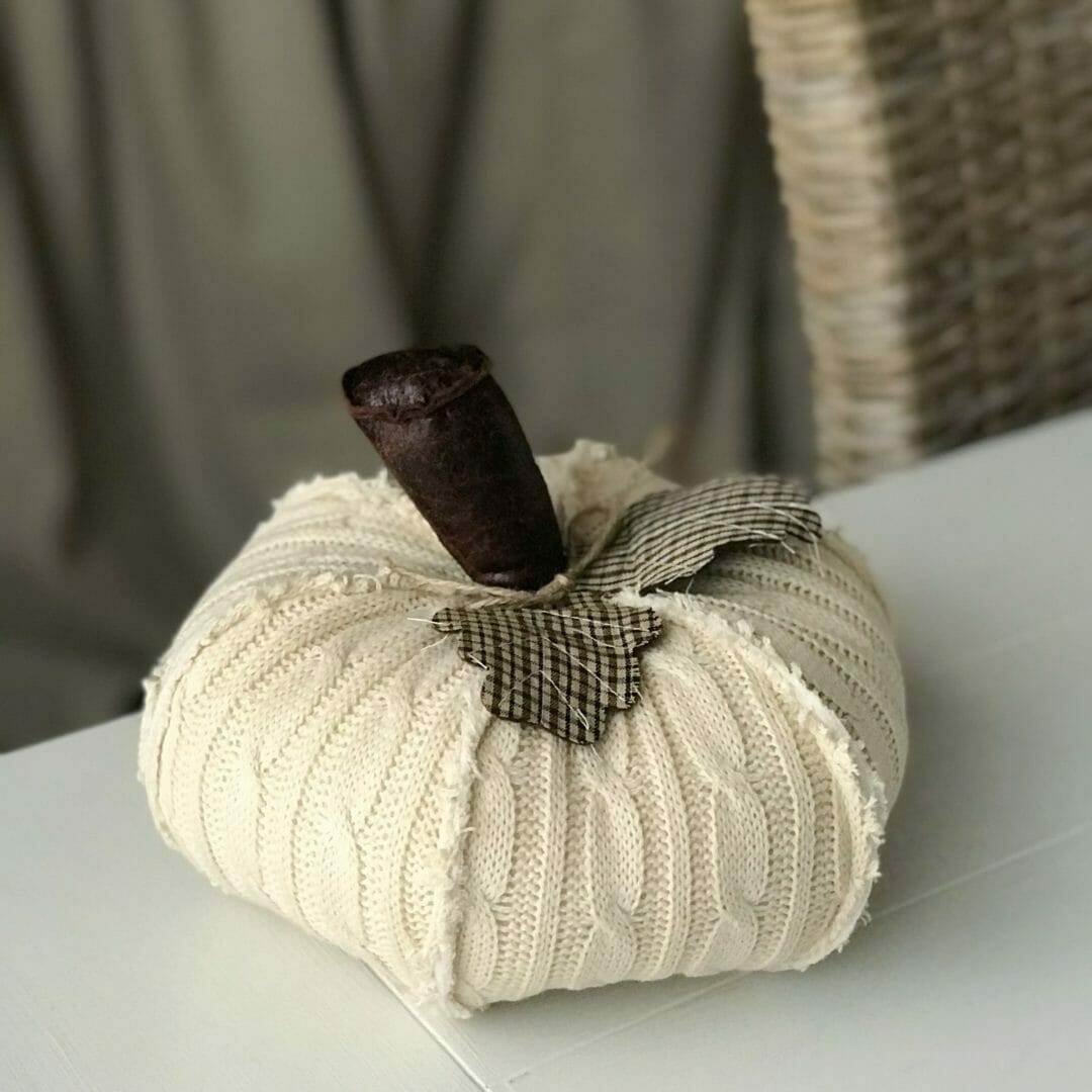 knit pumpkin with leather stem and cloth leaves