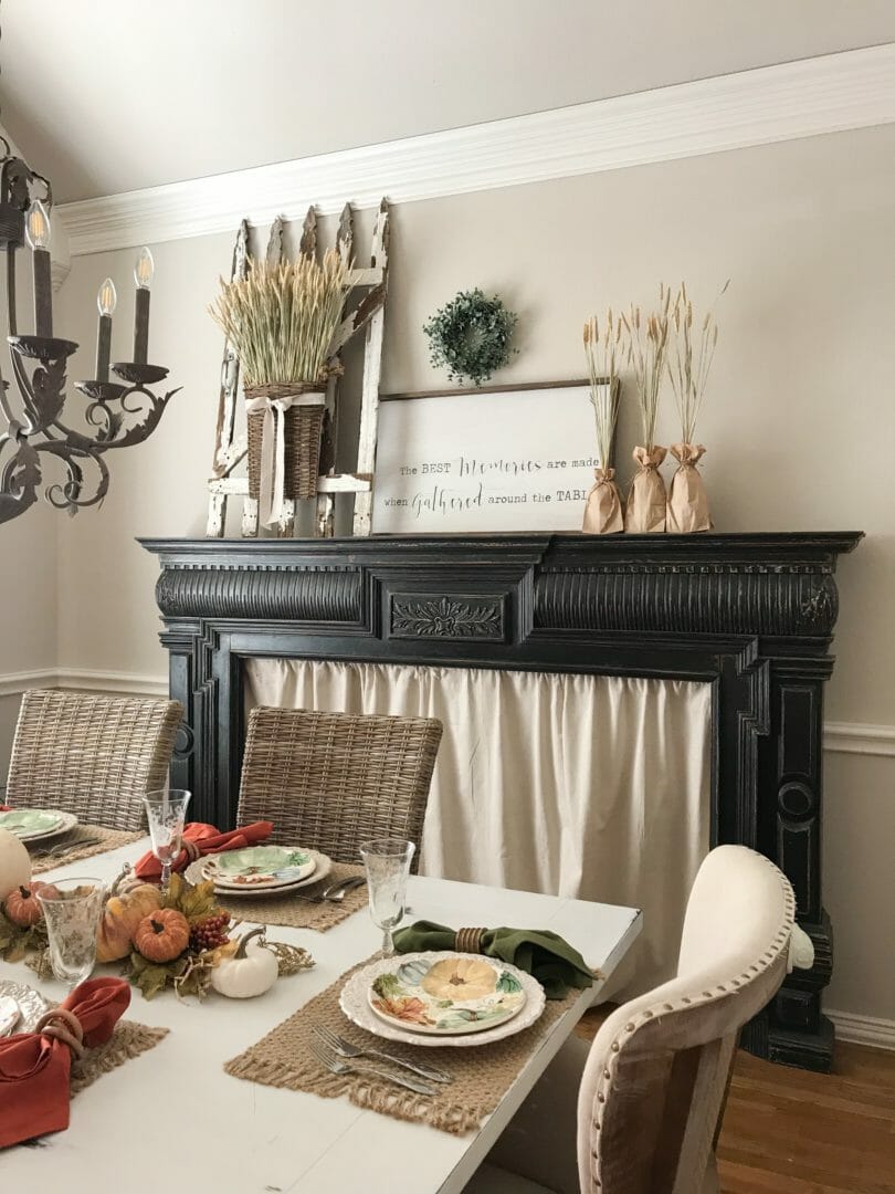 dining room with mantel and place settings