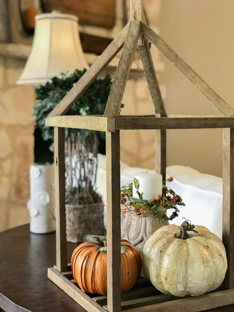 sofa table with wood house form and pumpkins