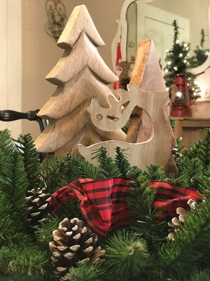 close up of wreath with ribbon and pinecones