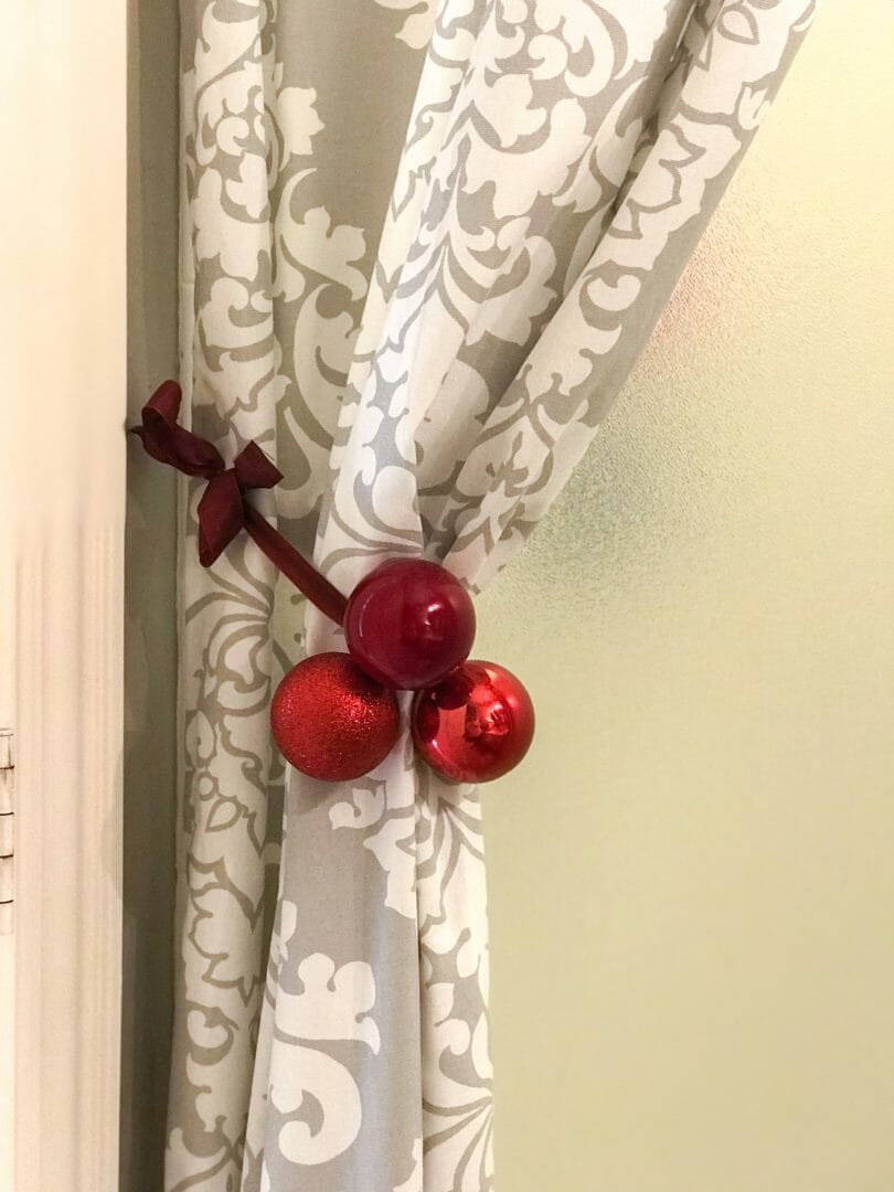 Shower curtain with red ornaments tied on