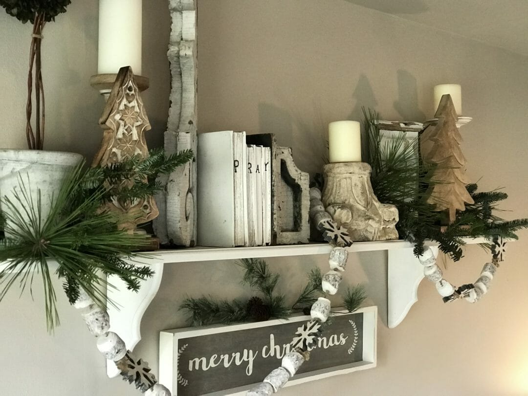 shelf with books, garland and candles
