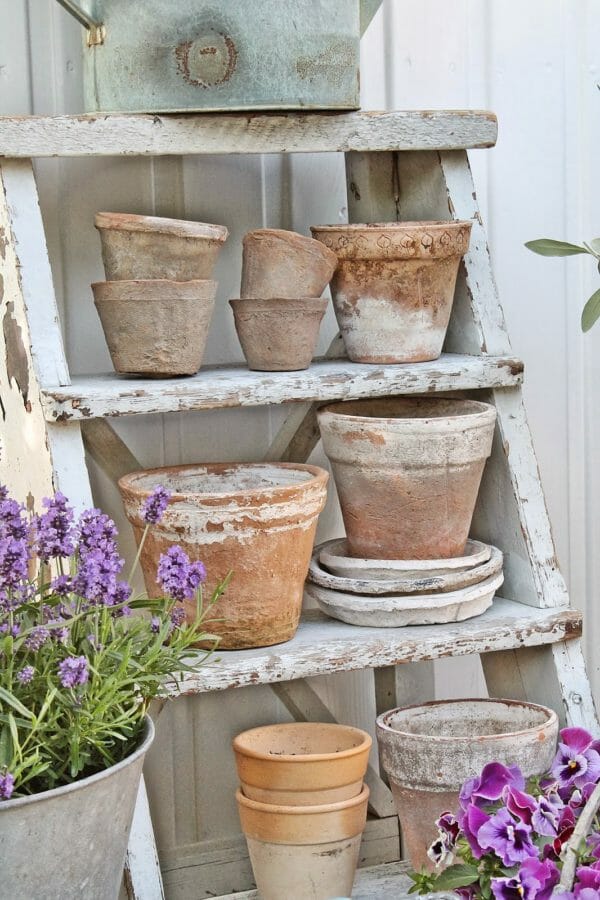 vintage clay pots on ladder