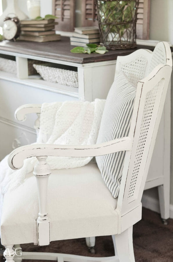 white cane chair with pillow