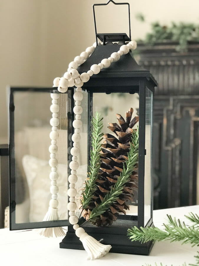 Winter lantern with pine cone and bead garland