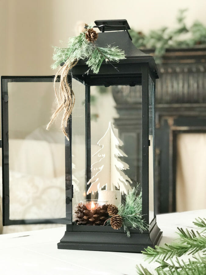 lantern with white tree and pine cones and candle