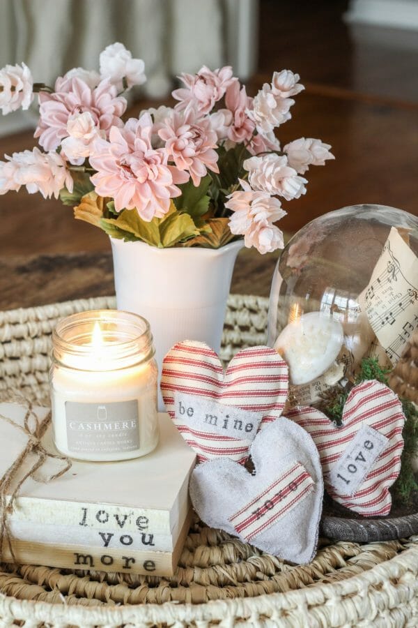 heart sachets with candle and vase of flowers