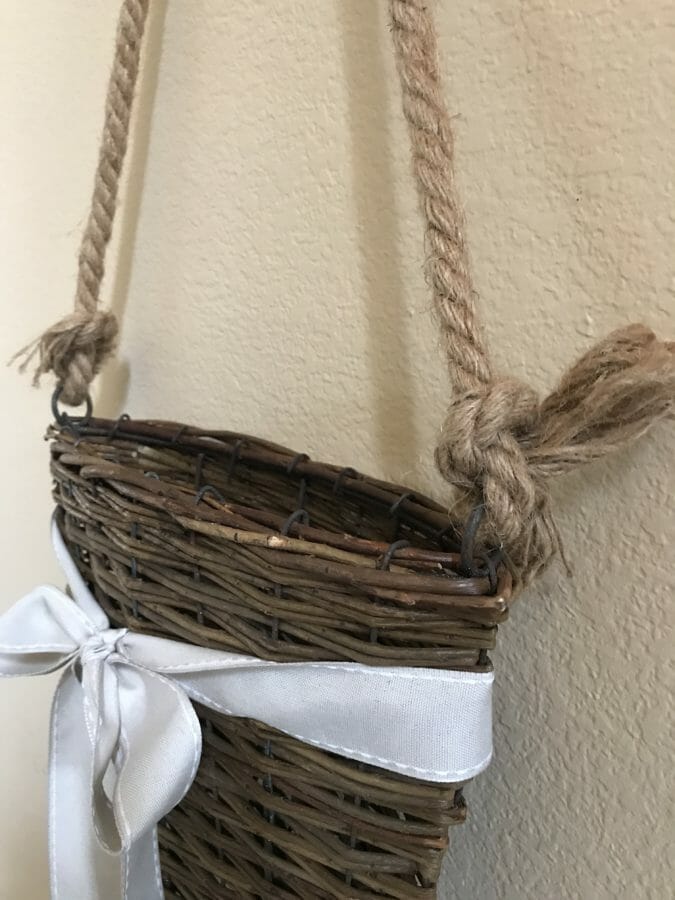 empty hanging basket with rope and bow