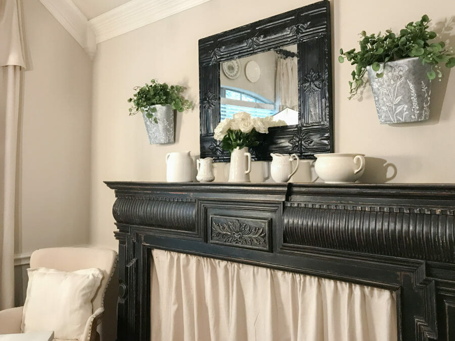 spring mantel with mirror and greenery in wall buckets