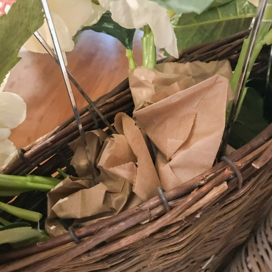 basket with brown paper and floral stems