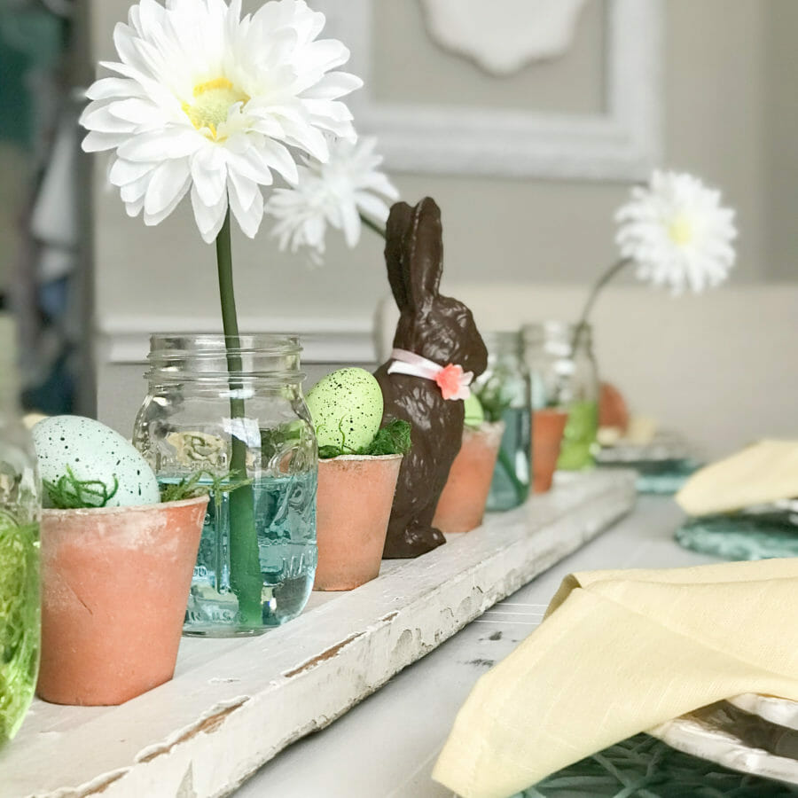 Easter centerpiece with clay pots, bunny and flowers